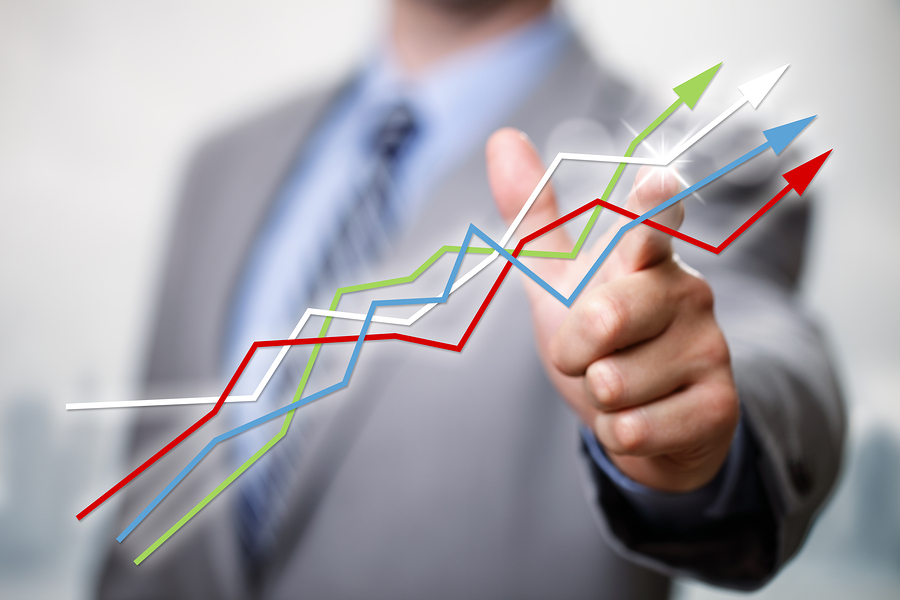 Businessman pointing to growth in a line graph showing business